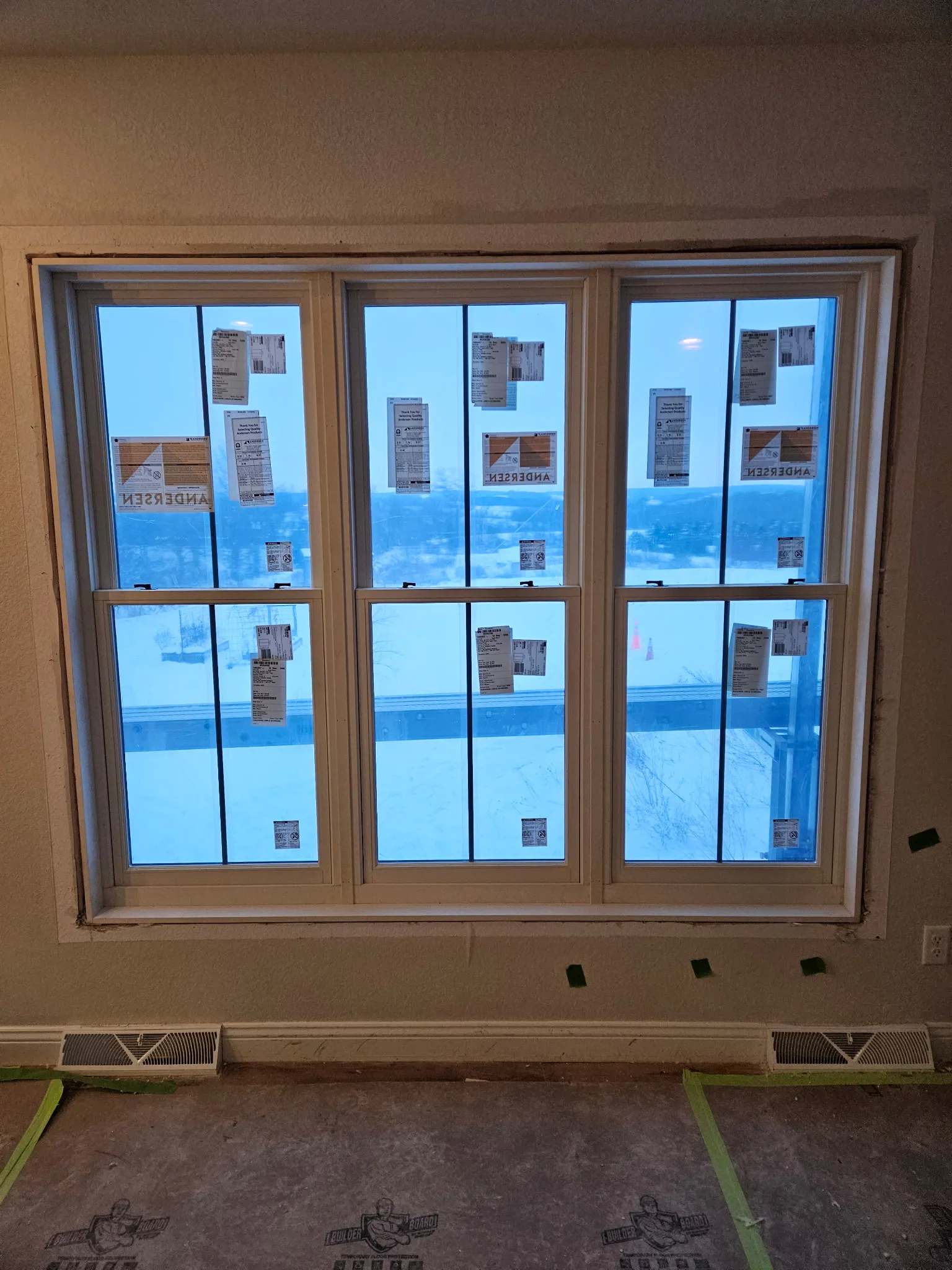 Close-up of insulated glass panes within a freshly caulked white window frame