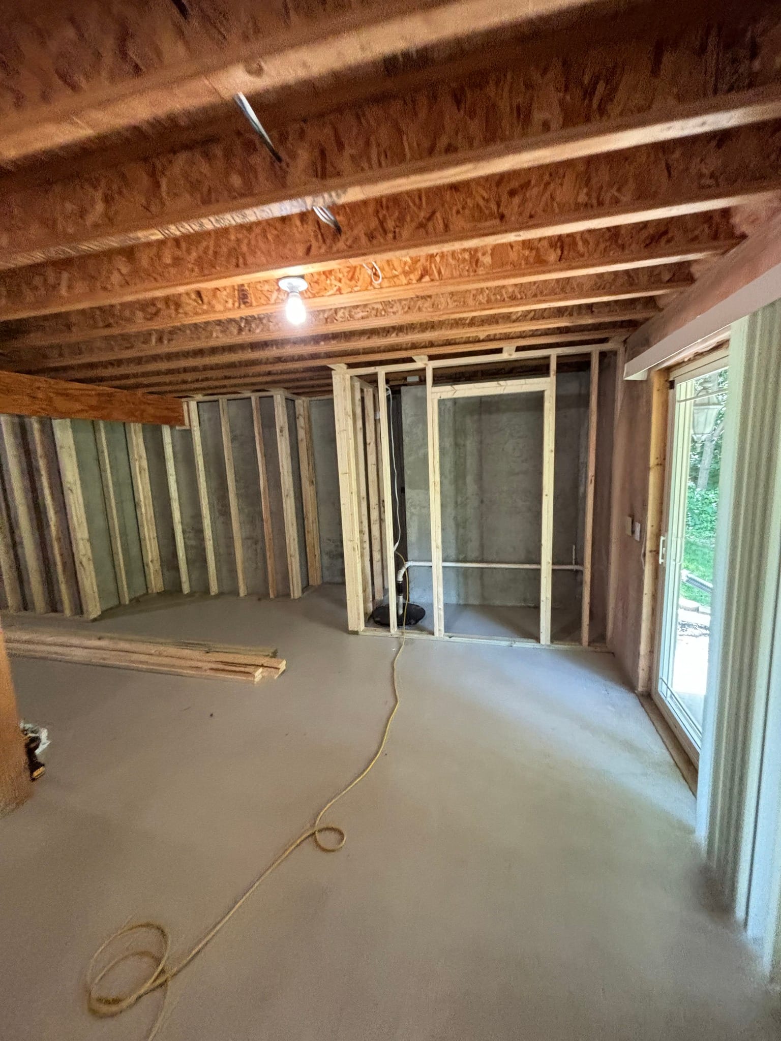 Exposed lumber framing showing doorway opening during interior home renovation