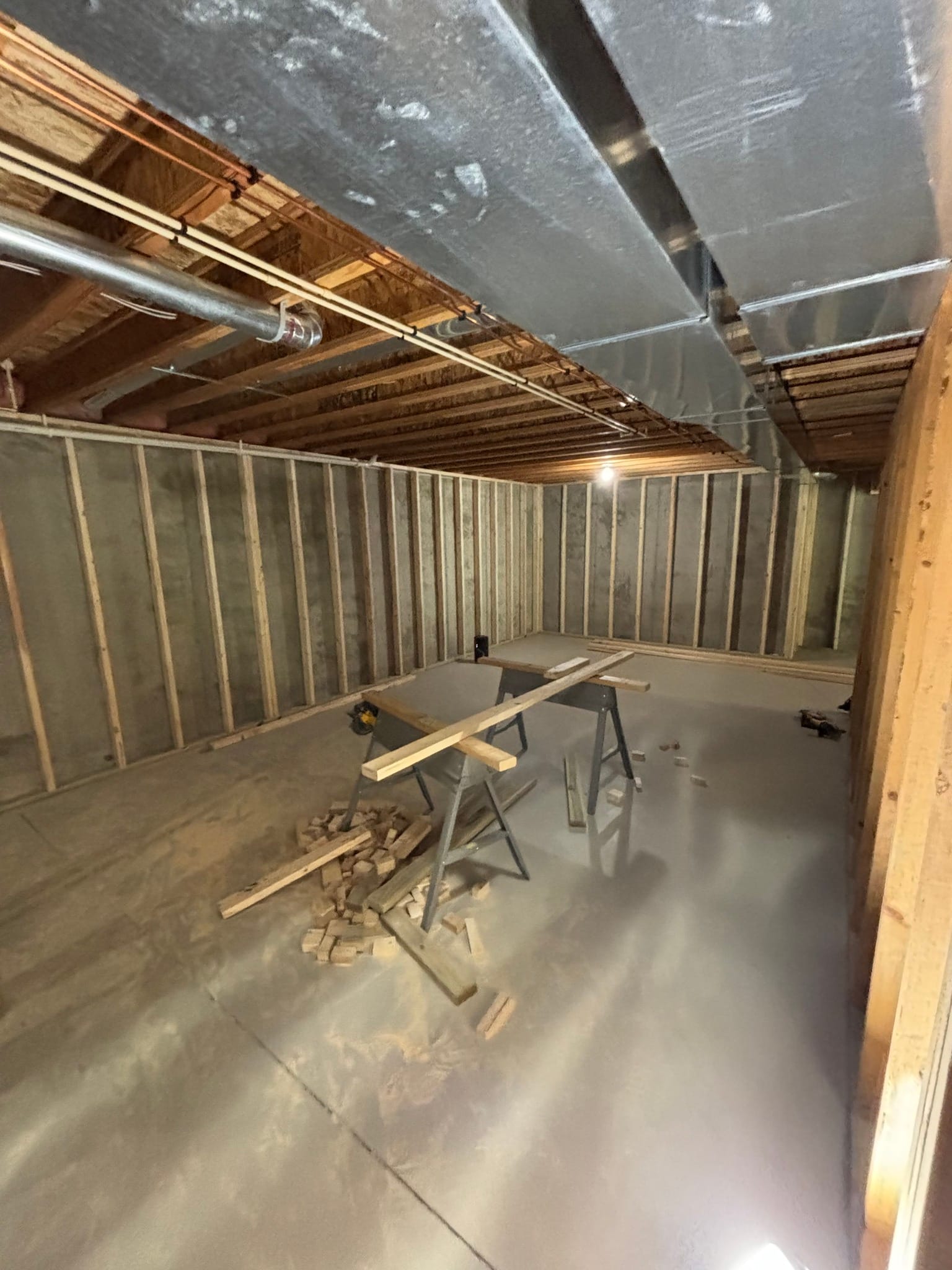 Wall framing studs erected inside a residential remodeling project under construction