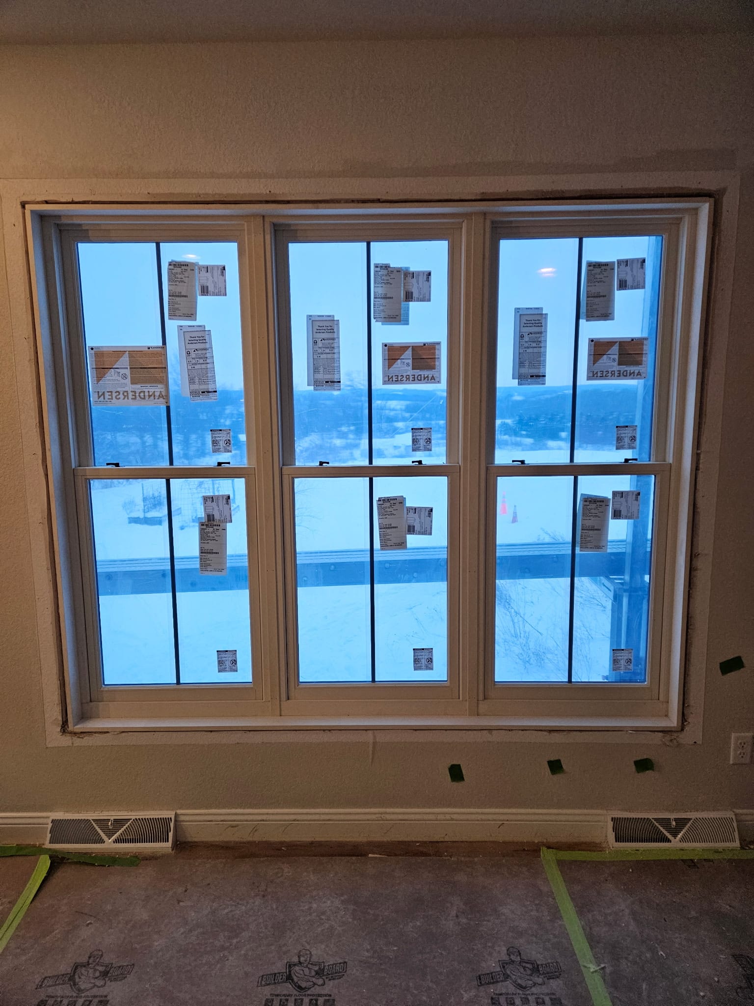 Technician leveling a new vinyl replacement window in a Mayville home